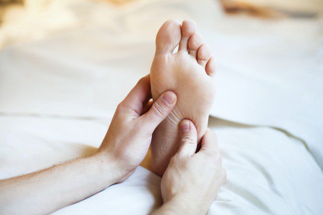 Foot massage on a bed