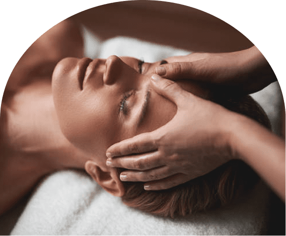 Woman receiving relaxing facial massage at spa